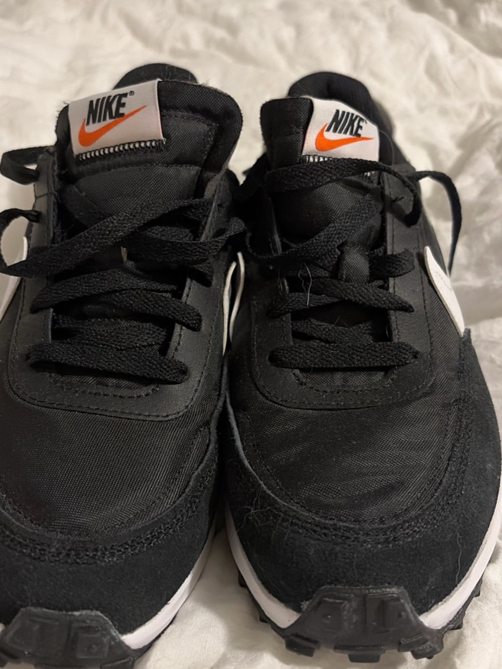 Nike Black Sneakers with White Swoosh and Orange Logo